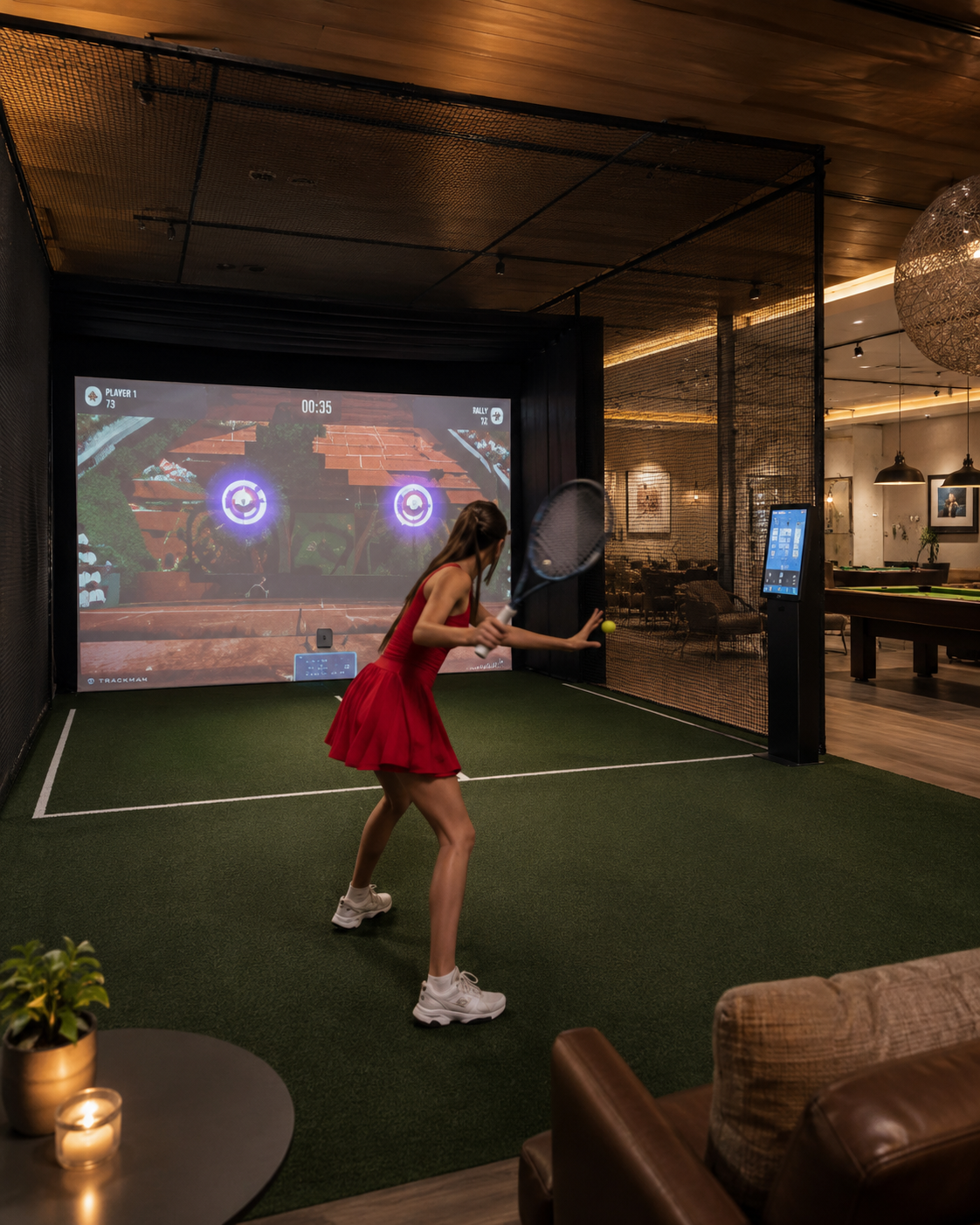 Guest playing on an indoor tennis simulator in a hotel leisure space