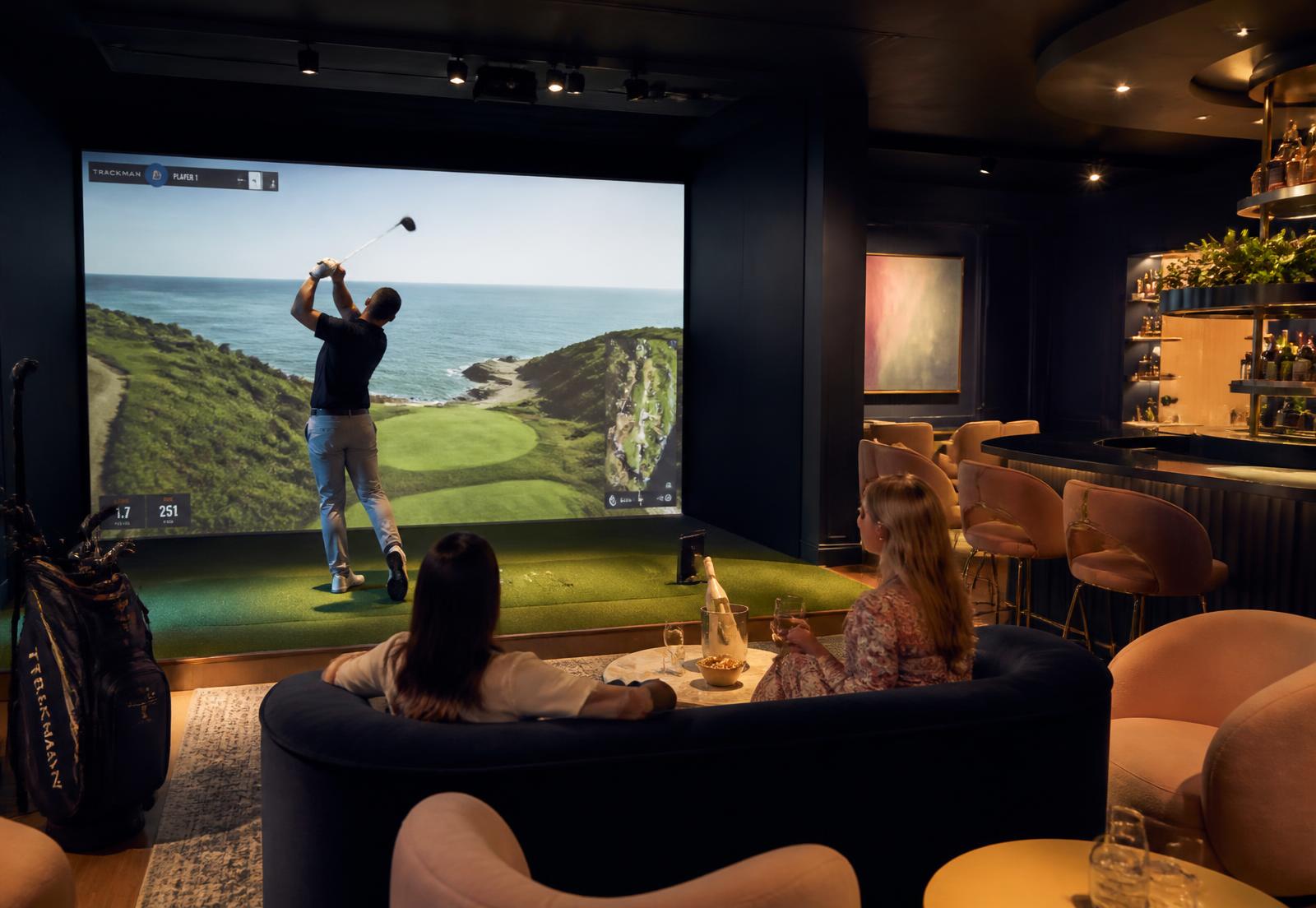 Guests in a luxury hotel golf simulator lounge